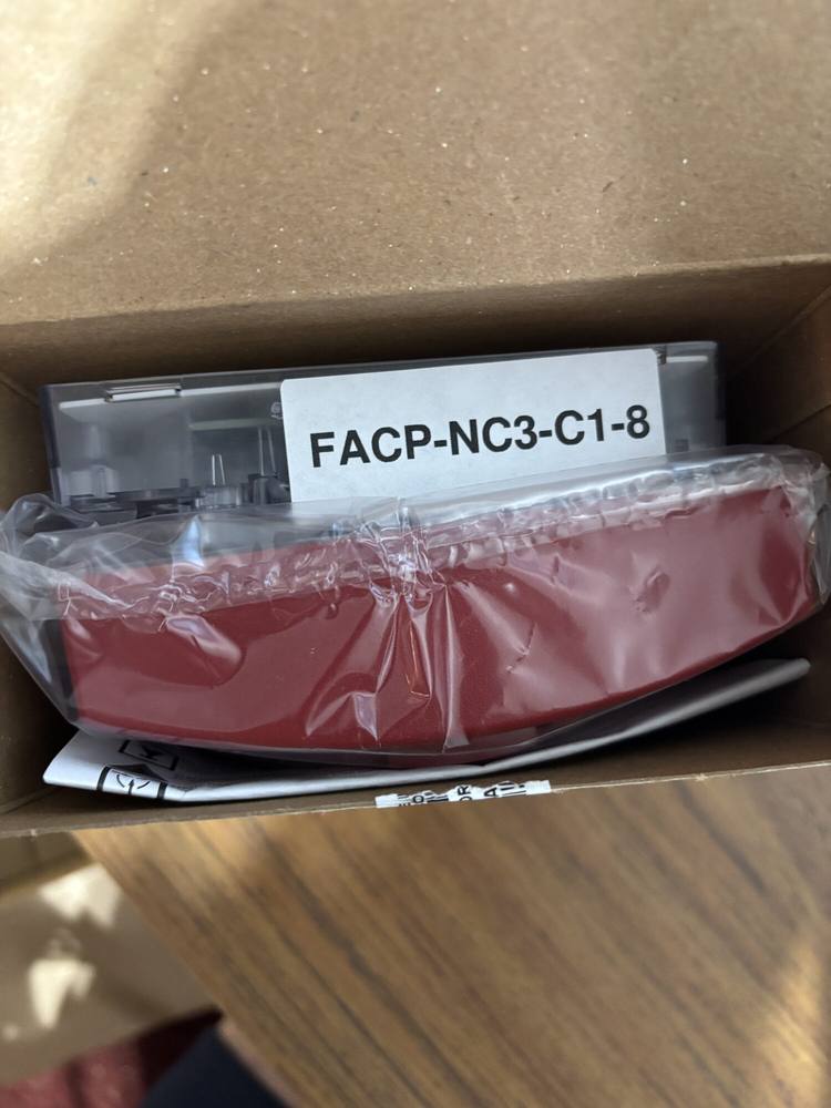 A packed carton with a large printed label reading FACP-NC3-C1-8 across the equipment inside.